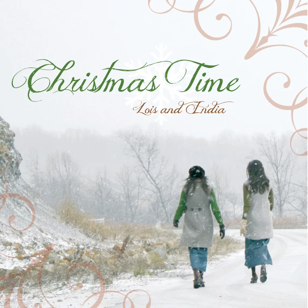Album cover for "Christmas Time". It features Lois and India walking int he snow with brown grass around them.